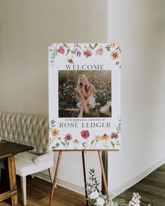 a welcome sign sitting on top of a wooden easel