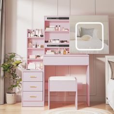 a pink desk with drawers and a mirror on the wall next to it in front of a bed