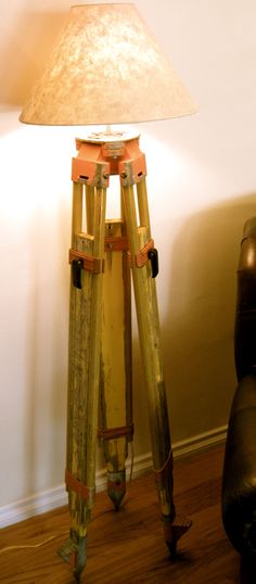 a lamp sitting on top of a wooden tripod