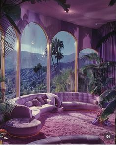 an extravagant living room with purple walls and floor to ceiling windows that overlook the mountains