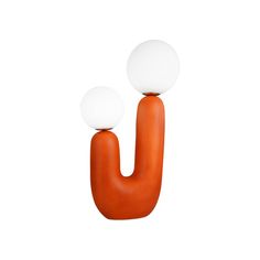 an orange object with two white balls on it's top and one is in the shape of a letter u