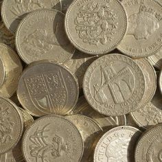 a pile of silver coins sitting on top of each other