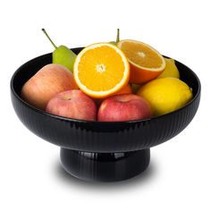 a black bowl filled with apples, oranges and pears on a white background