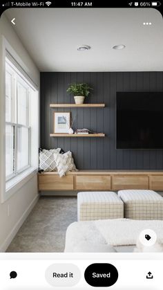 the room is decorated in black and white with wooden shelves, built into the wall