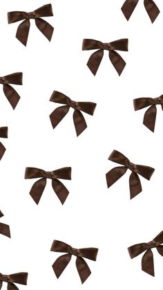 many brown bows are flying in the air