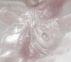 a close up view of the inside of someones hand with pink liquid on it