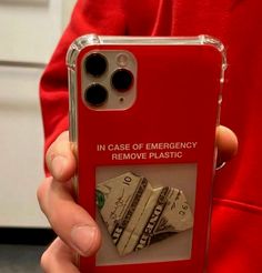 a person holding a red case with money on it and the words in case of emergency remove plastic