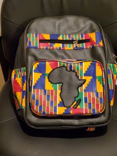 Whether you are running errands, commuting or heading to school; carry your belongings in style. Generously sized backpack made with authentic African printed fabric. Continent of Africa proudly displayed on the front pocket. This item is a product of our partnership with various makers of the Accra Art Centre in Ghana. Kitenge Bags Design, Kente Cloth Art Lesson Project For Kids, Ankara Handbags Kitenge, African Print Laptop Bags, African Print Backpack, African Accessories, Accra, Diy Tote Bag, African Print Fabric