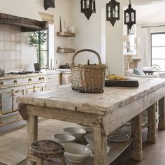 a large wooden table sitting in the middle of a kitchen