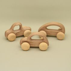 three wooden toy cars sitting next to each other