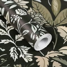 a black and white floral wallpaper with leaves on the back ground, it looks like something from another era