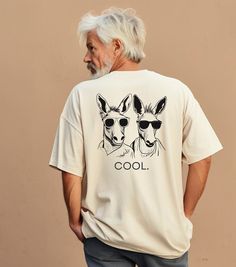 Are you a DONKEY LOVER or know someone who is? This cotton t-shirt featuring two hilarious donkeys sporting sunglasses with the word "COOL" is the perfect and funny gift for anyone, especially donkey lovers. Enjoy comfort and laughter in style! *Small design on front, large design on back.* Thank you for stopping by and supporting our small business! Our products are perfect for group trips, events, gifts, and any occasion. We hope they bring a smile to your face. : ) Please check out our entire Etsy Storefront for other fun and unique T-shirts, accessories & gifts. We know you have many options to choose from, WE TRULY APPRECIATE YOUR SUPPORT! If you need a large order with additional sizes, customization and/or a design more specific to accommodate your trip or event, let us know! Group Bad Donkey Shirt, Cool Crew Neck T-shirt With Funny Print, Cool Relaxed Fit T-shirt With Funny Print, A Donkey, Small Design, T Shirt Funny, Matching Shirts, Unique Tshirts, Small Designs