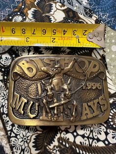 Bishop Mule Days Buckle Vintage Celebrate the rich tradition of Bishop Mule Days with this vintage buckle. Featuring intricate detailing, this buckle is a perfect collectible for enthusiasts or a stylish accessory for everyday wear. Whether you're a lifelong fan of the Mule Days event or a vintage buckle collector, this piece is sure to stand out in your collection. Gold Antique Buckle Vintage Belt Buckles, Vintage Gold Belt Buckle With Antique Detail, Gold Antique Buckle Vintage Belt Buckle, Gold Antique Buckle Vintage Belt, Gold Vintage Belt Buckle With Antique Detail, Vintage Gold Belt Buckles As Gift, Vintage Adjustable Belt Buckles With Brass Buckle, Vintage Adjustable Belt Buckles For Formal Wear, Vintage Brass Buckle Belt Buckles As Gift