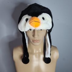 Penguin Fuzzy Stuffed Plush Animal Hat W/ Earmuff Protection Unisex Playful Adjustable Winter Costume Hats And Headpieces, Winter Novelty Adjustable Costume Hats, Fun Black Warm Hats, Playful Black Warm Hats, Black Cap For Winter Costume, Novelty Winter Costume Hats And Headpieces, Playful Winter Costume Hats And Headpieces, Playful Black Winter Hats, Penguin Hat