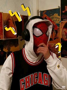 a person wearing a spider man hoodie and headphones with the word chicago on it