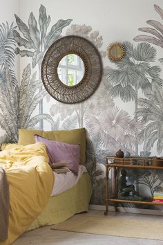 a bedroom with wallpaper and a mirror on the wall