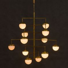 a chandelier with eight lights hanging from it's sides and four on each side