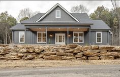 a house that has some rocks in front of it