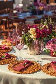 the table is set with place settings and wine glasses