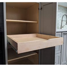 an open cabinet door in a kitchen