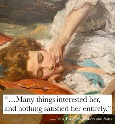 a woman laying on top of a bed next to a painting with a quote about her