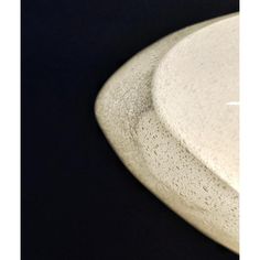 a white plate sitting on top of a black table