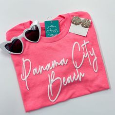 Panama City Beach T-Shirt | Aubrey and Oliver Pink Funny Text T-shirt For Summer, Pink Short Sleeve T-shirt For Day Out, Casual Neon T-shirt With Screen Print, Trendy Summer T-shirt With Lettering, Casual Summer T-shirt With Lettering, Trendy Pink T-shirt With Text Print, Summer Short Sleeve T-shirt With Lettering, Fun Summer T-shirt With Text Print, Summer T-shirt With Text Print For Day Out