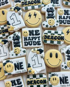 decorated cookies are arranged in the shape of smiley faces and numbers with words on them