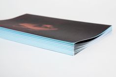 a stack of blue books sitting on top of a white table