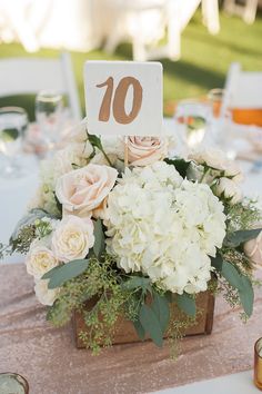 there is a table with flowers and candles at the end of it that says 10