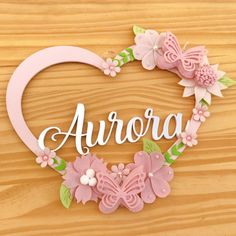 a heart shaped sign that says aurora with flowers and butterflies in the shape of a heart