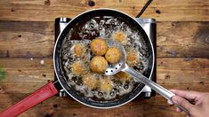 someone is frying some food in a pan