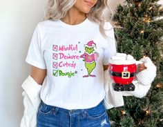 Very Mindful Very Demure Very Bougie Grinch Tshirt, Grinch Tshirt, Universal Studios tshirt, Christmas tshirts, Seuss Land, dr seuss All T-Shirts are a unisex fit. If you would prefer a fitted t-shirt please contact us before ordering to discuss.  Size Guides are within the images. How do I wash my product? Machine wash inside out at 30C. Do not use detergent that contains bleach or Fabric softener. DO NOT TUMBLE DRY. Iron inside out using a very low temperature, taking care to avoid the printed Grinch Universal Studios Shirt, Grinch Tshirt, Universal Shirts, The Grinch, Dr Seuss, Fabric Softener, Christmas Tshirts, Grinch, Womens Clothing Tops