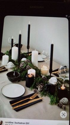 the table is set with candles and plates