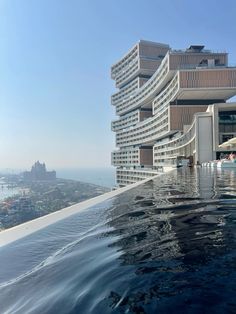 an outdoor swimming pool next to a tall building