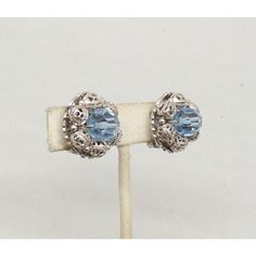 This is part of Chairish’s Costume Jewelry assortment.  Circa early 1960s rhodium plated round faceted blue glass bead center with rhodium plated filigree beads with small smooth rhodium bead spacers surrounding the center butterfly clip back earrings. Marked "Napier Pat. Pend." Measure: 3/4 inches across. Excellent condition. Vintage Crystal Earrings For Formal Occasions, Vintage Silver Round Crystal Earrings, Silver Round Bead Costume Earrings, Blue Metal Clip-on Earrings, Vintage Metal Earrings With Round Beads, Vintage Metal Beaded Earrings, Blue Metal Clip-on Jewelry, Vintage Blue Clip-on Jewelry, Silver Round Clip-on Earrings For Evening