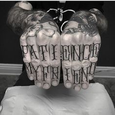 two hands that have tattoos on them with words written in the middle and one is holding out their hands