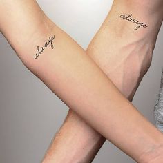 two people holding hands with tattoos on their arms that say always and always in cursive writing