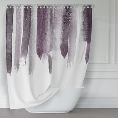 a shower curtain with purple and white paint streaks on it, hanging from the side of a bathtub