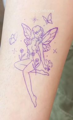 a tattoo on the leg of a woman with a fairy tinkerbell sitting on top of it