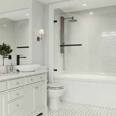 a white bathroom with black and white tile flooring