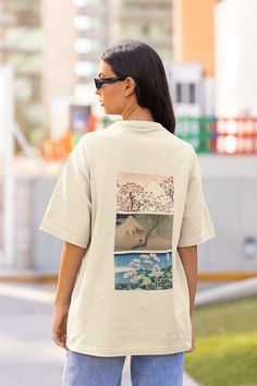 🖼 Products Details 🖼 - A collage of Katsushika Hokusai artwork printed beautifully onto a soft, gildan graphic tee, - All work focused on Mount Fuji - White, Beige, Navy, Baby Blue, Green and Black - The design is printed on the back of the t-shirt, the front is blank - Sizing depends on your desired fit, size-up for an oversized fit or choose your usual size for a fitted look. (Please bare in mind all our t-shirts are unisex) 🧼 Material & Care 🧼 - All our t-shirts are 100% cotton - Machine Artistic Oversized Graphic Tops, Oversized Artistic White Top, Artsy Short Sleeve Tops With Artwork, Artistic Oversized Printed Top, Oversized Artistic Printed Top, Casual Crew Neck Tops With Artwork, Mont Fuji, Graphic Tee Outfits, Oversized Graphic Tee