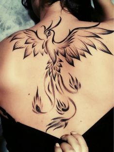 a woman with a bird tattoo on her back