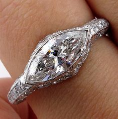 a woman's hand with a diamond ring on it