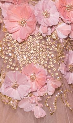 pink and gold flowers are on the back of a dress that is covered in sequins