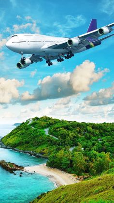 an airplane is flying over the water and land