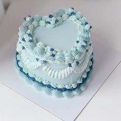 a heart shaped cake sitting on top of a table