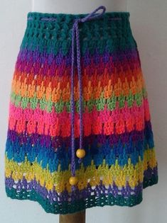 a multicolored crocheted skirt on a mannequin