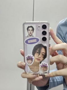 a person holding up a cell phone case with an image of someone's face on it