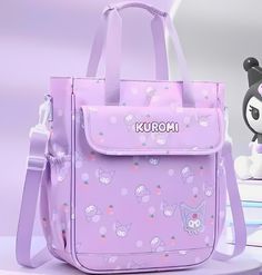 Hello Kitty Campus Messenger Bag Girls Hello Kitty Pattern Purple School Bag Waterproof, Stain Resistant, Large Capacity Flap Book Bag Travel Weekender Girls Ladies JK Bag  Discover the perfect blend of whimsy and practicality with this adorable Sanrio Kuromi Strawberry Pattern Campus Messenger Bag. This spacious and charming accessory features a delightful soft purple background adorned with classic Kuromi faces, polka dots, and strawberry motifs. A Kuromi face logo is embroidered on the bottom corner while the name KUROMI is emblazoned across the top front. The lightweight yet durable design makes it ideal for everyday use, whether you're heading to school, work, or catching a plane. With its roomy interior and inner pockets, you'll have plenty of space to carry all your books or essenti Purple Harajuku Student Bag, Purple Harajuku Style Student Bag, Cute Hello Kitty Print School Shoulder Bag, Kawaii Hello Kitty Print Travel Bag, Kawaii Shoulder Bag With Zipper Closure, Harajuku Style Purple Bag For Back To School, Kawaii Hello Kitty Print School Shoulder Bag, Purple Shoulder Bag For Daily Use, Back To School, Cute Hello Kitty Print Bag For Students